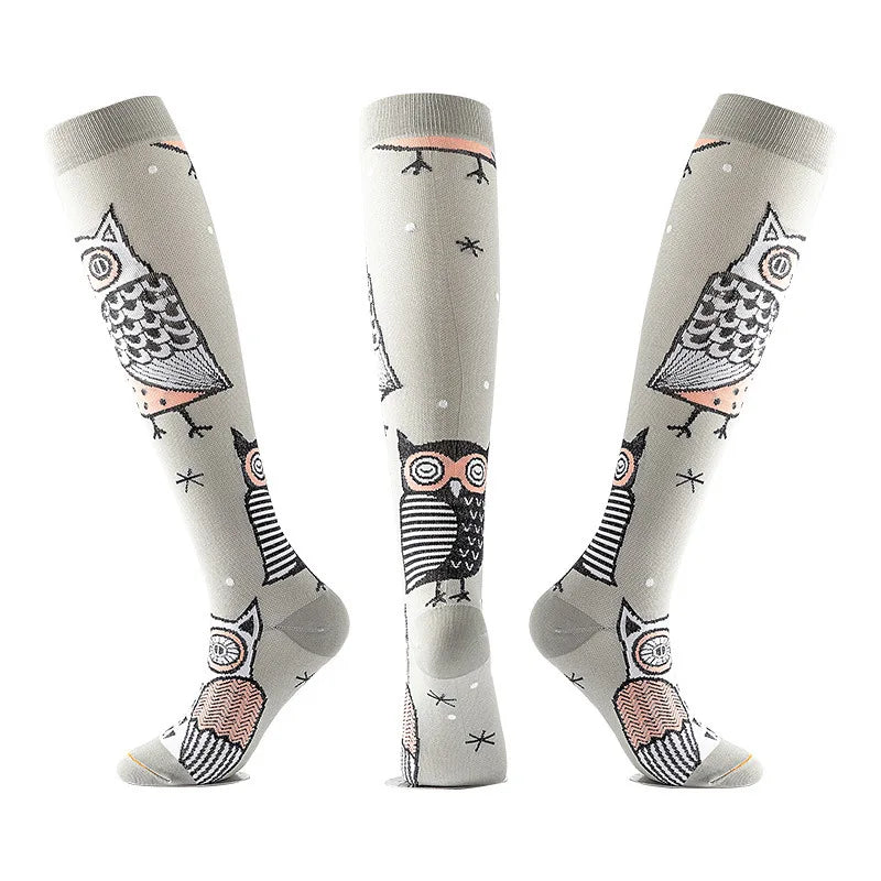 A set of multi-color compression socks featuring owl designs on a light gray background.