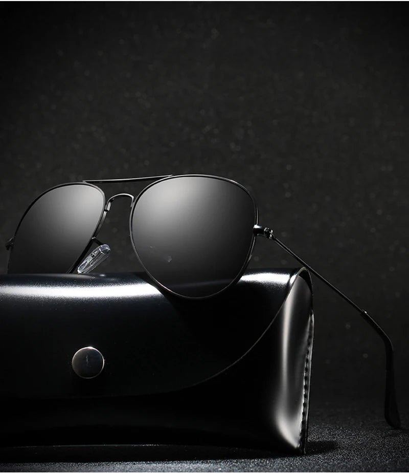 A pair of black polarized pilot sunglasses resting on a black leather case.