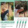 Close-up of LED arrow nocks used for archery, shown in a natural outdoor setting.