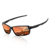 A pair of black polarized sports sunglasses with orange-tinted lenses reflecting a city skyline at sunset.