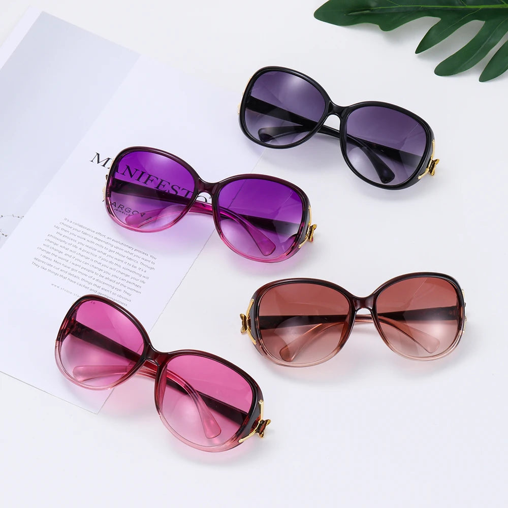 A set of three vintage oversized retro sunglasses in purple, brown, and pink tones displayed on a white background.