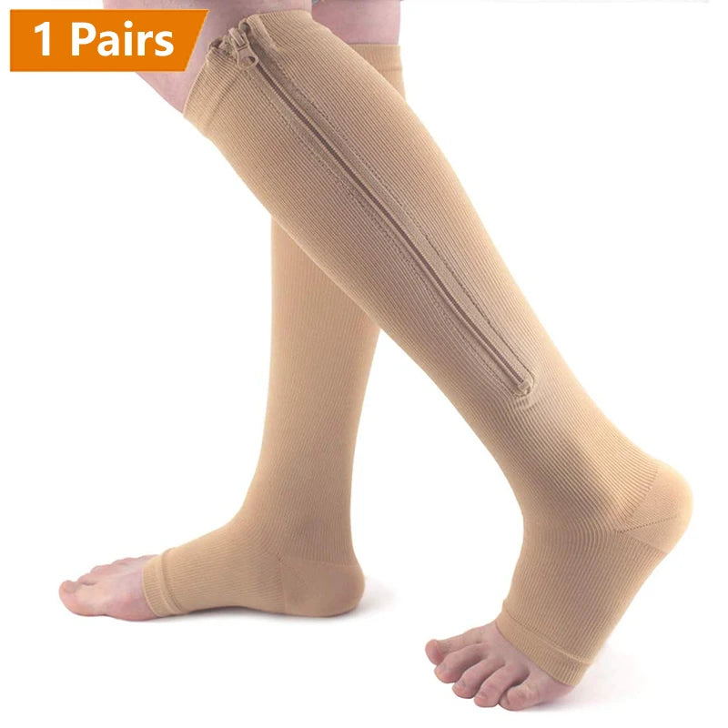 A pair of beige zipper compression socks being worn on a person's leg.