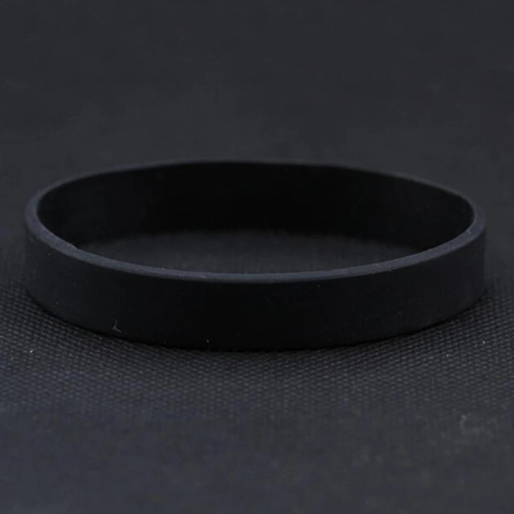 A black silicone elastic wristband is shown against a dark background.
