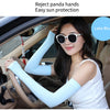 A woman wearing light blue fingerless arm sleeves for sun protection inside a car.
