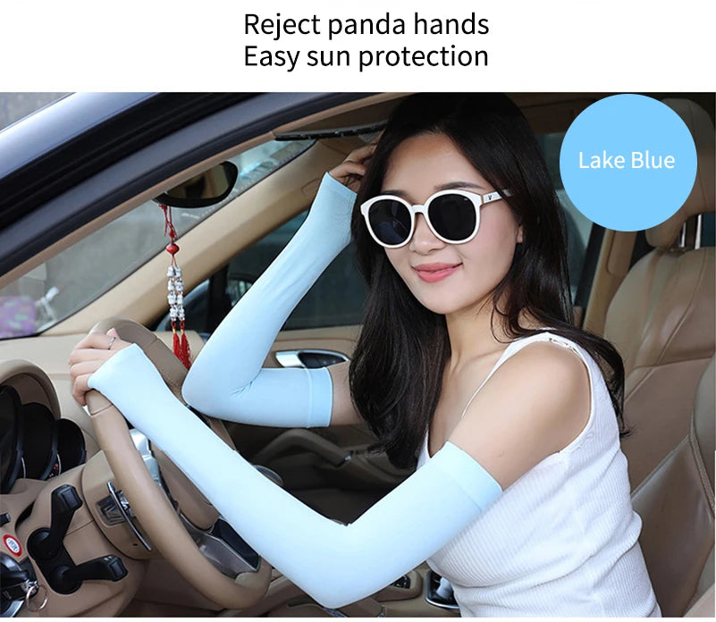 A woman wearing light blue fingerless arm sleeves for sun protection inside a car.