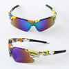 A pair of sporty sunglasses with multi-colored lenses and black frames are shown against a white background.