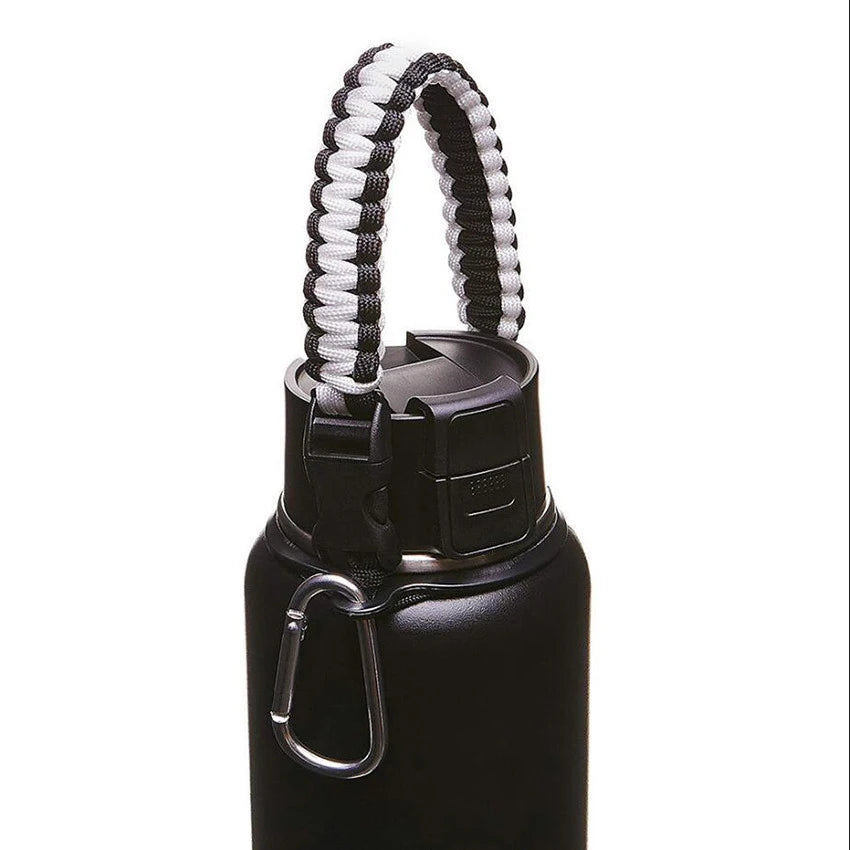 Black water bottle with a white paracord strap for hiking and travel