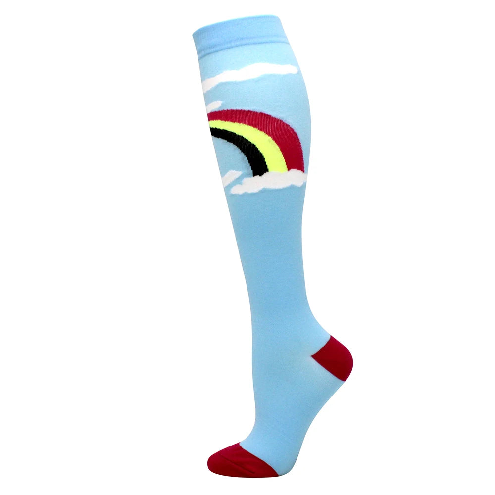 Light blue compression socks featuring a rainbow design on the calf and red tips.