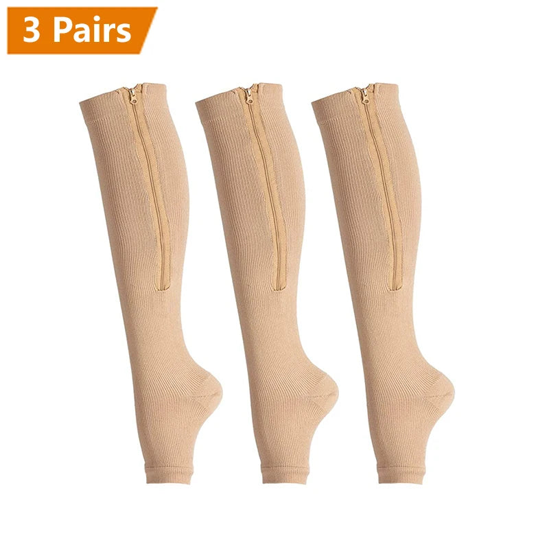 Three pairs of beige zipper compression socks shown standing upright.
