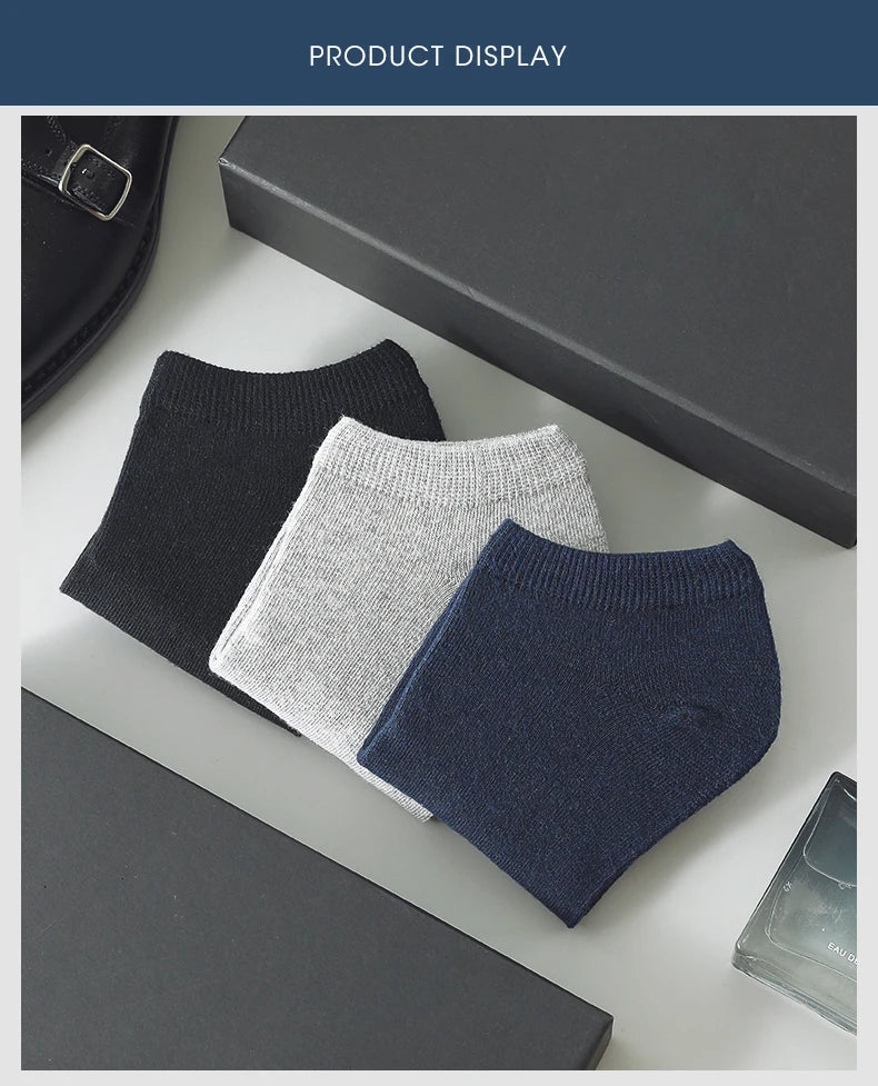 A display of three pairs of women's thin cotton no-show socks in black, light gray, and navy blue.