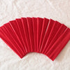 A fan of bright red elastic headbands arranged in a semi-circle on a white surface.