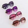 A set of four vintage oversized retro sunglasses in shades of black, purple, pink, and brown.