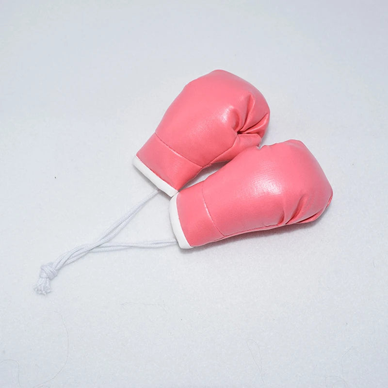 Guante de boxeo de cuero rosa con puño blanco y cuerda delgada para llavero.