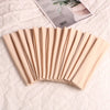 A fan of beige elastic headbands for sports and hair displayed on a white surface next to a product label.
