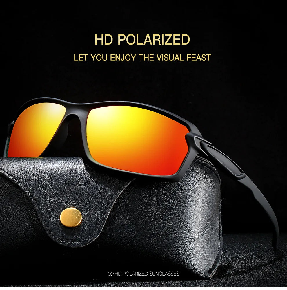 A pair of black sunglasses with orange lenses resting on a black leather case.