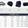 A set of men's swim gear including goggles, a cap, and earplugs displayed in separate boxes.