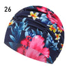A dark blue and pink floral patterned elastic nylon turban swimming cap.