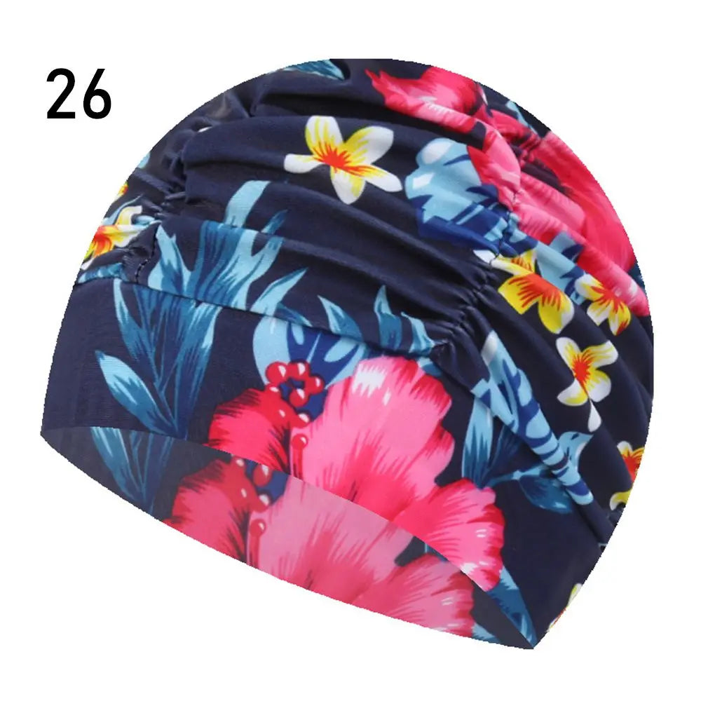 A dark blue and pink floral patterned elastic nylon turban swimming cap.