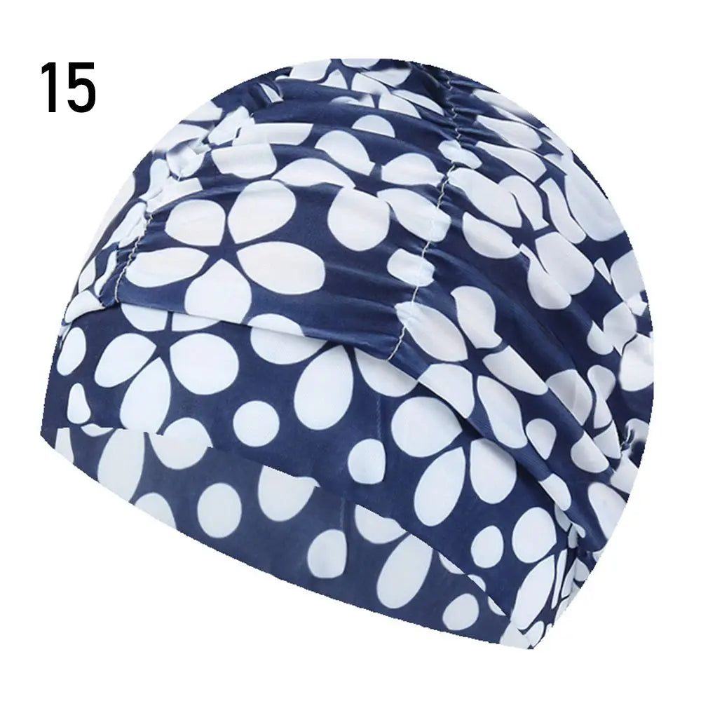 A navy blue and white patterned elastic nylon turban swimming cap shown from the side.