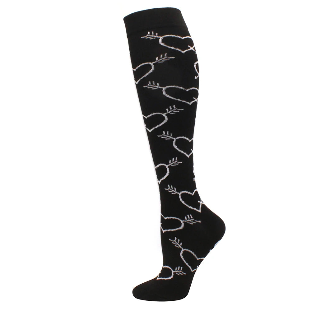 Black medical grade compression socks with a repeating heart pattern for circulation and vein support