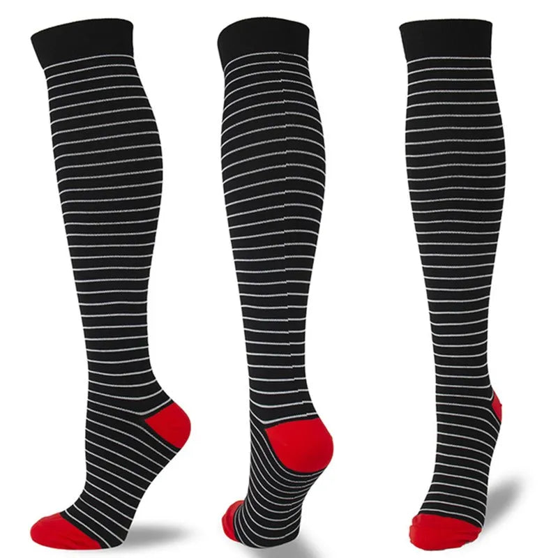 A set of black compression socks with red accents shown vertically.