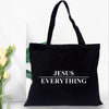 Black canvas tote bag with the text Jesus Everything printed on it.