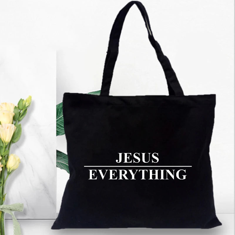 Black canvas tote bag with the text Jesus Everything printed on it.