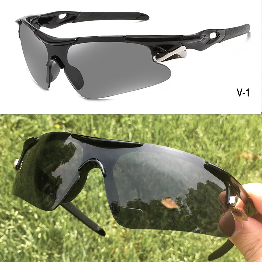 A pair of black sport sunglasses resting on a hand, reflecting greenery.