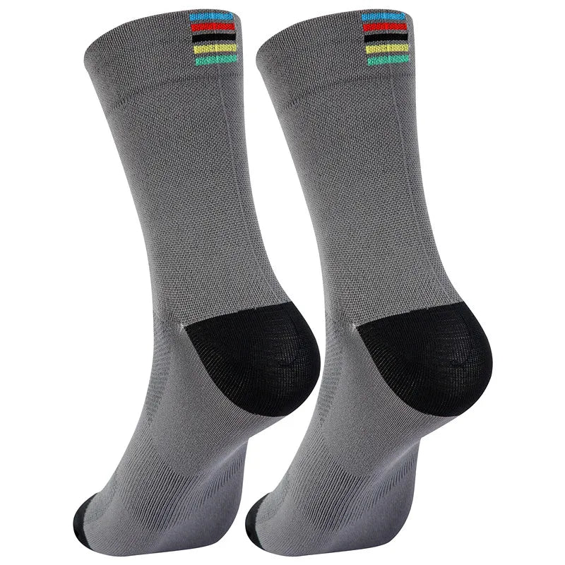 A pair of grey performance cycling and sports socks with colored stripes at the top.