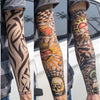Close-up of a person wearing colorful, patterned reusable UV protection tattoo arm sleeves on their forearm.