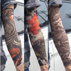 A close-up of a person wearing colorful, detailed tattoo arm sleeves on their forearm.