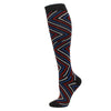Black compression socks with a geometric pattern of red and blue stripes