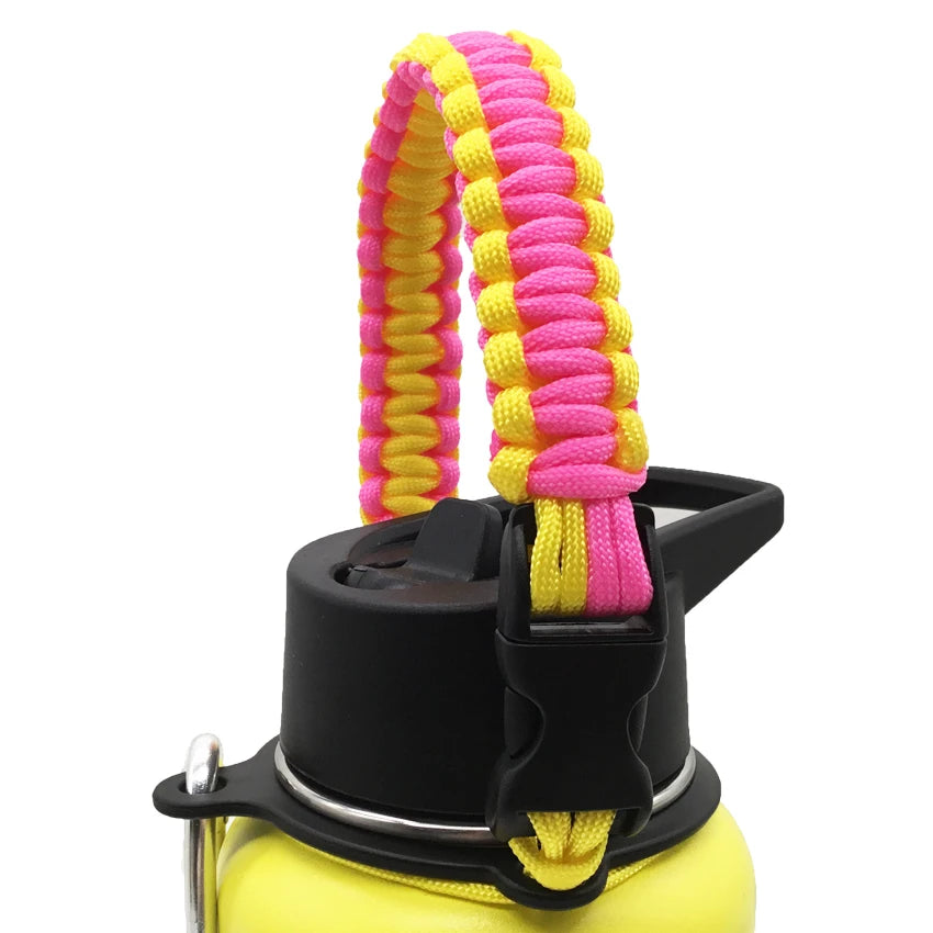 A yellow water bottle with a pink and yellow paracord strap attached.