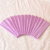 A fan of light purple elastic headbands arranged in a semi-circle on a white textured fabric.