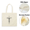 A beige canvas tote bag featuring a black cross design, shown with and without a zipper and a liner pocket.