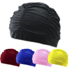 A set of black, blue, pink, and yellow elastic nylon turban swimming caps shown in various shades.