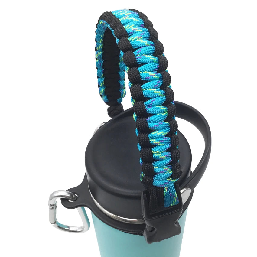 A black water bottle with a blue and black paracord strap attached.
