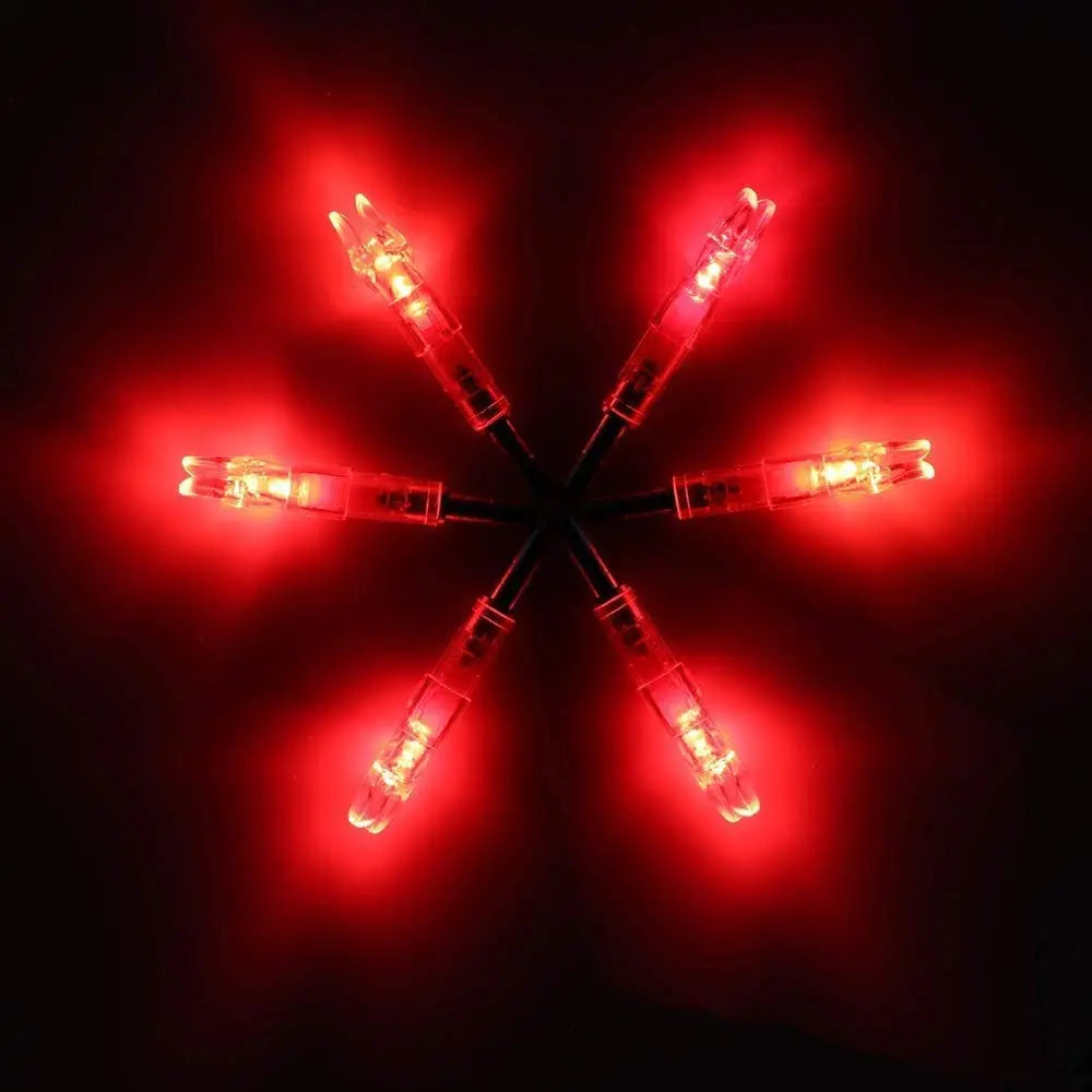 A set of lighted arrow nocks for archery, glowing bright red against a dark background.