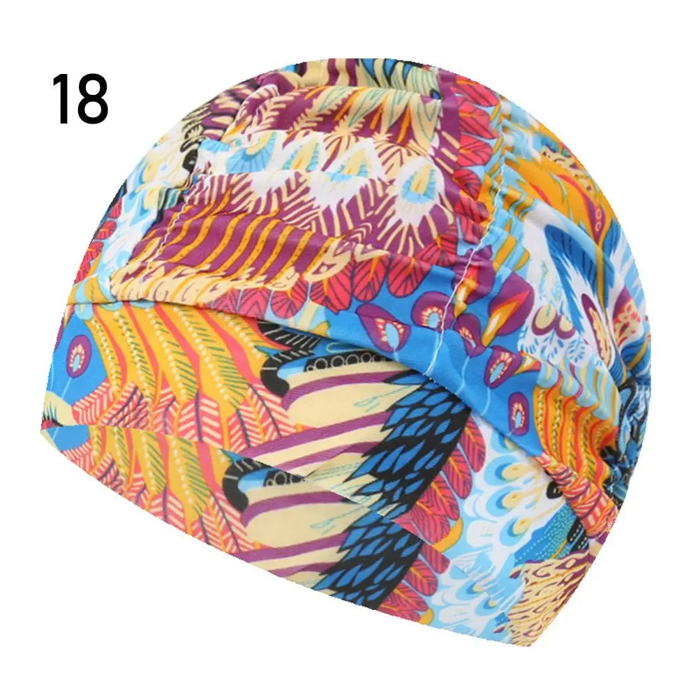 A colorful elastic nylon turban swimming cap with a vibrant floral and abstract pattern.