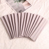 A fan of multi-use elastic headbands for sports and hair in a soft pink color.