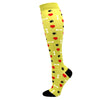 Yellow compression socks patterned with red hearts and black paw prints