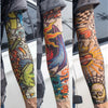 Close-up of a person wearing colorful reusable UV protection tattoo arm sleeves with intricate designs.