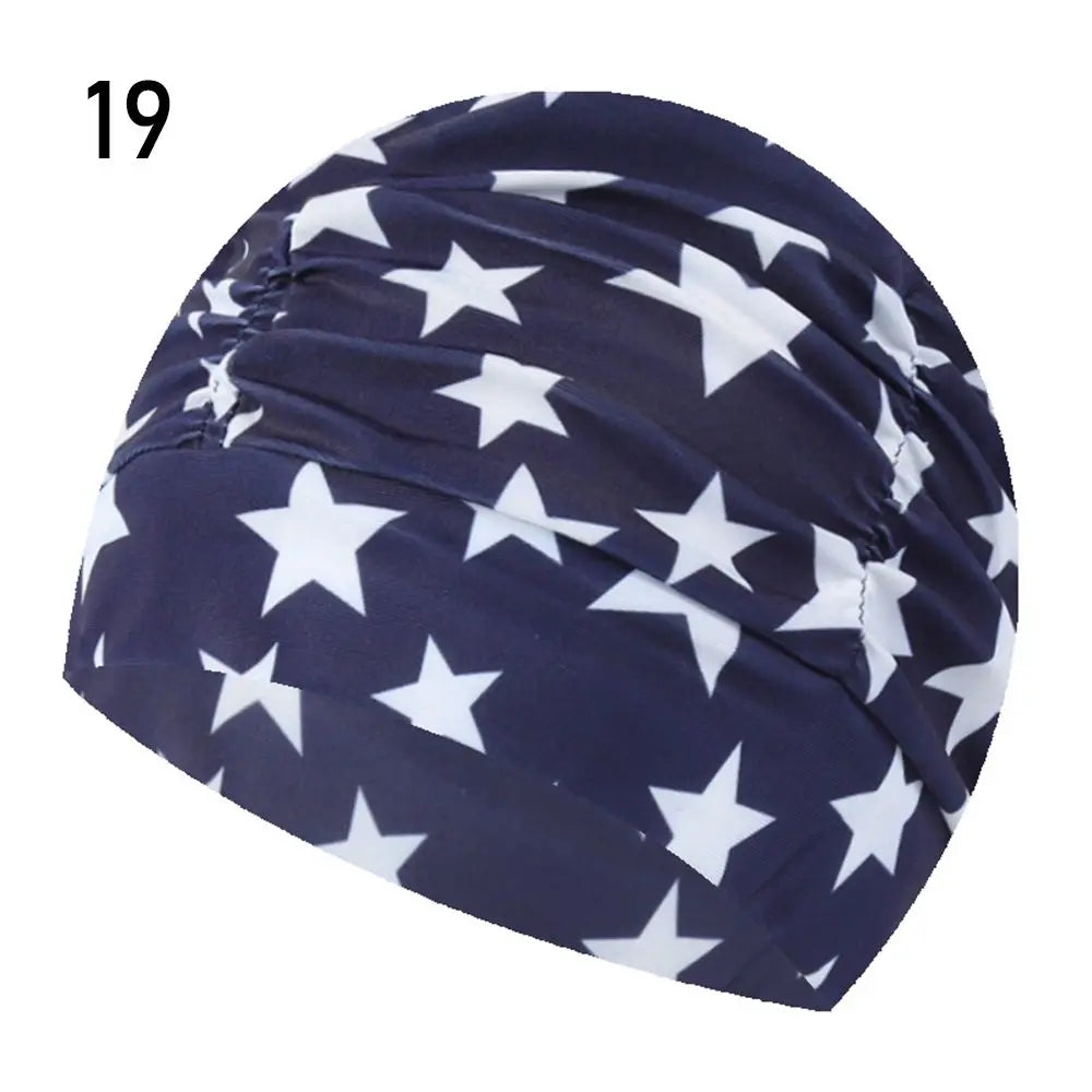 Navy blue and white star patterned elastic nylon turban swimming cap.