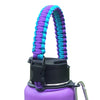 Purple paracord strap attached to a black bottle, used for hiking and travel.