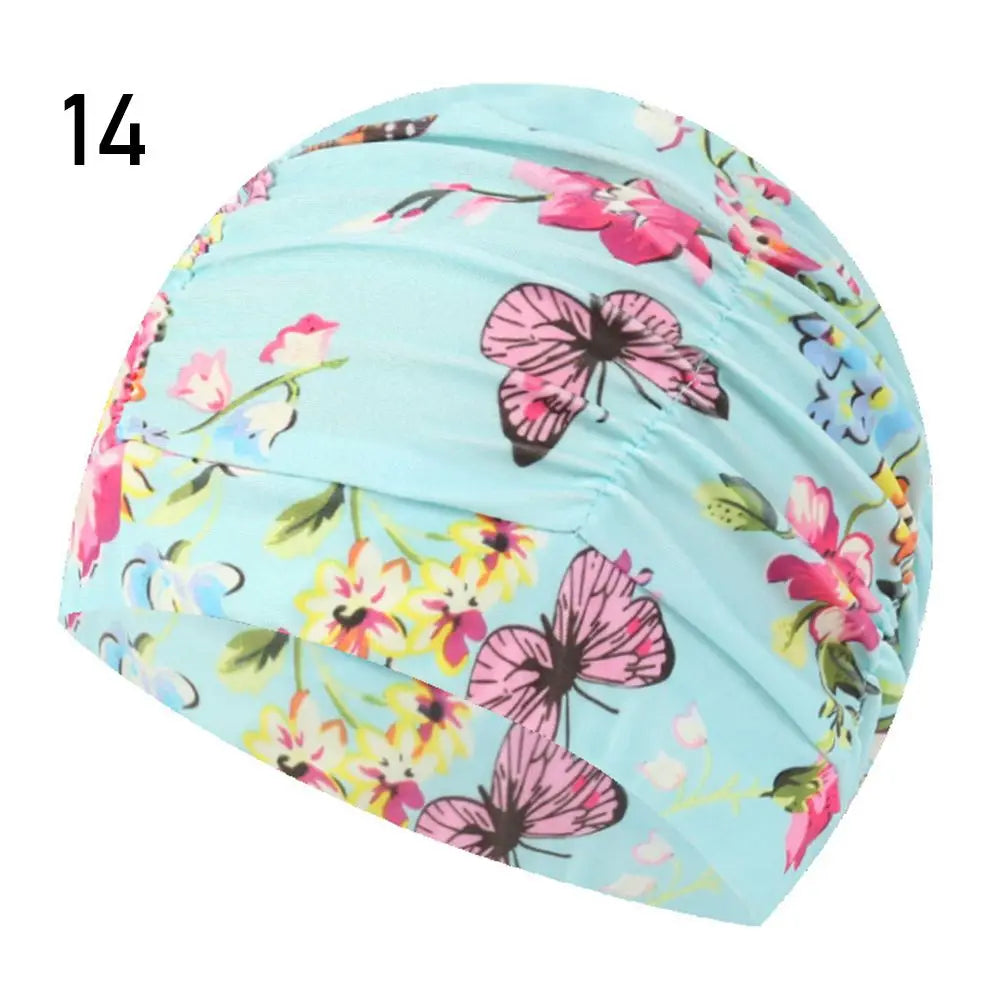 Light blue elastic nylon turban swimming cap with a floral print featuring pink and yellow flowers.