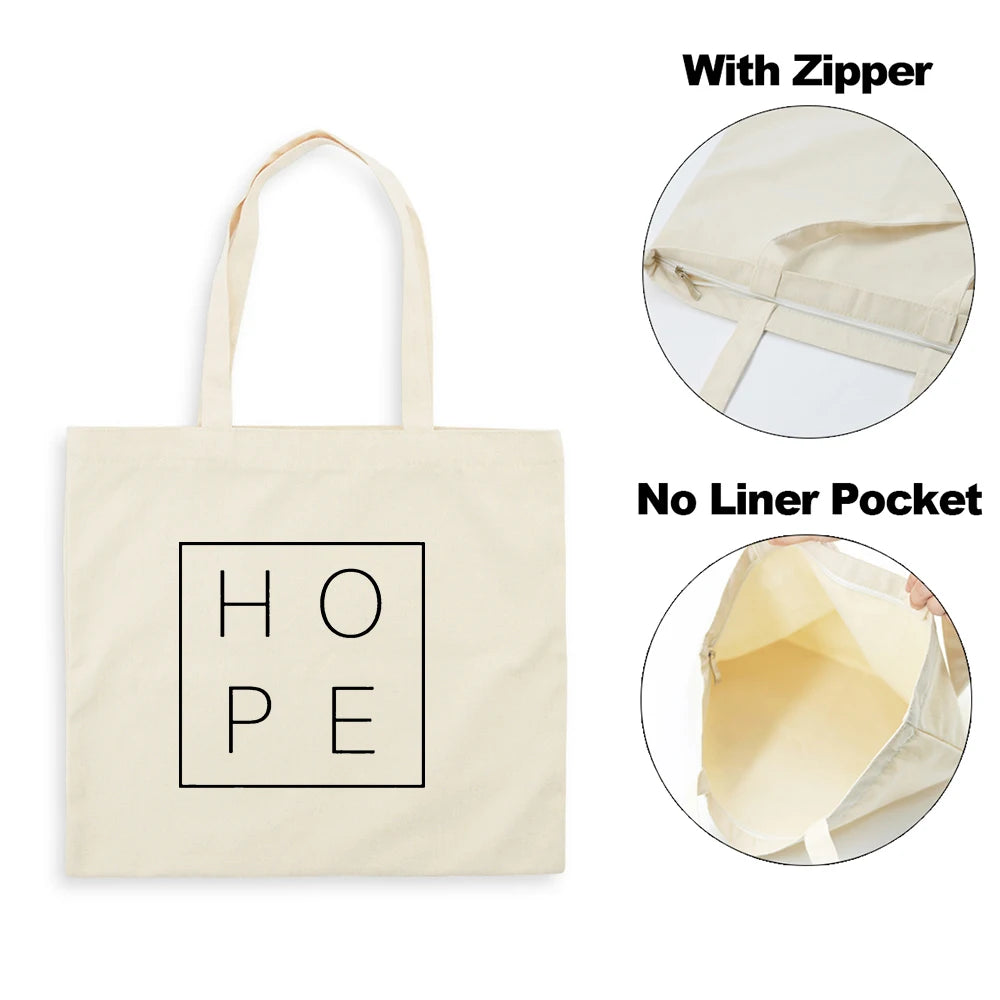A beige canvas tote bag featuring the word HOPE in a square font, shown with and without a zipper and a liner pocket.