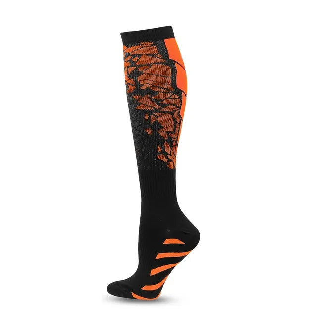 A pair of black compression socks with orange patterned stripes.