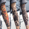 Close-up of a person wearing reusable UV protection tattoo arm sleeves with intricate black and orange designs.