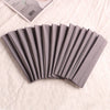 A fan of gray elastic headbands rolled into a neat stack on a white fabric background.