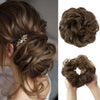 A close-up of messy curly hair bun extensions styled in a textured updo with gold accents.